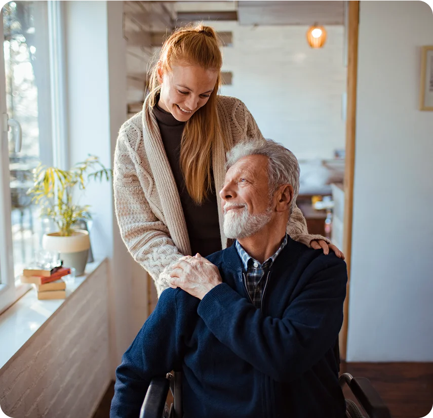 Young woman with elderly man in wheelchair.